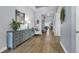 Long hallway with hardwood floors, elegant decor, and a view of the bright, airy interior at 16238 Misty Hills Ave, Winter Garden, FL 34787