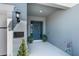 Welcoming entryway featuring a vibrant front door, stylish lighting, and lush greenery at 16238 Misty Hills Ave, Winter Garden, FL 34787