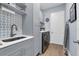 Laundry room with gray cabinets, stylish backsplash, sink, and laundry machines at 16238 Misty Hills Ave, Winter Garden, FL 34787