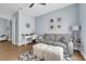 Living room featuring neutral walls, wood flooring, a gray sofa, and a white fur ottoman at 16238 Misty Hills Ave, Winter Garden, FL 34787