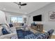 Cozy living room with a sectional sofa, modern entertainment center, and plenty of natural light at 16238 Misty Hills Ave, Winter Garden, FL 34787
