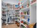 Walk-in pantry with lots of shelving that offers efficient storage for all your kitchen essentials at 16238 Misty Hills Ave, Winter Garden, FL 34787