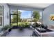 Screened lanai featuring a comfortable seating area and a lush green backyard view at 16238 Misty Hills Ave, Winter Garden, FL 34787