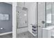 Elegant walk-in shower with tiled walls and a rainfall shower head, designed for relaxation at 16238 Misty Hills Ave, Winter Garden, FL 34787
