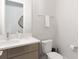 Stylish powder room features a modern vanity, elegant fixtures, and toilet at 1014 Jack Nicklaus Ct, Reunion, FL 34747