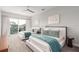 Serene bedroom showcasing two beds, carpet, and a sliding glass door to a balcony at 1014 Jack Nicklaus Ct, Reunion, FL 34747