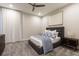 Cozy bedroom with a plush bed, a ceiling fan, and contemporary furnishings at 1014 Jack Nicklaus Ct, Reunion, FL 34747