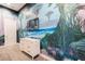Cool ' bedroom featuring a custom mural, tv, and a dresser at 1014 Jack Nicklaus Ct, Reunion, FL 34747