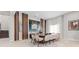 Spacious dining room featuring modern decor, a large table, and stylish artwork at 1014 Jack Nicklaus Ct, Reunion, FL 34747