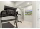 Private exercise room featuring a modern treadmill and wall-mounted TV for entertainment during workouts at 1014 Jack Nicklaus Ct, Reunion, FL 34747