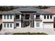 Striking exterior of modern two-story home with stone details and well-kept landscaping at 1014 Jack Nicklaus Ct, Reunion, FL 34747