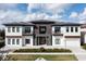 Beautiful modern two-story home with stone accents, a tile roof, and manicured landscaping at 1014 Jack Nicklaus Ct, Reunion, FL 34747