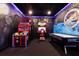 Entertainment space with games and custom wall art at 1014 Jack Nicklaus Ct, Reunion, FL 34747