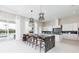 Bright, open kitchen featuring a large island with bar stools and modern appliances at 1014 Jack Nicklaus Ct, Reunion, FL 34747