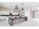 Spacious kitchen featuring a large island with seating and modern, stainless steel appliances at 1014 Jack Nicklaus Ct, Reunion, FL 34747