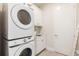 Bright laundry room features stacked washer/dryer and functional design at 1014 Jack Nicklaus Ct, Reunion, FL 34747