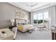 Bright main bedroom with a large window, stylish furnishings, and neutral decor at 1014 Jack Nicklaus Ct, Reunion, FL 34747