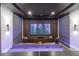 Home cinema with a large screen and cozy lounge seating, complete with ambient lighting and stylish decor at 1014 Jack Nicklaus Ct, Reunion, FL 34747