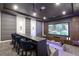 Home theater with bar seating, ambient lighting, and a large screen for the ultimate viewing experience at 1014 Jack Nicklaus Ct, Reunion, FL 34747