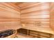 Inviting at-home sauna with wood paneling, tiered benches, and traditional sauna accessories at 1014 Jack Nicklaus Ct, Reunion, FL 34747
