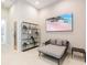 Sitting room with a modern shelf, TV and stylish chaise lounge at 1014 Jack Nicklaus Ct, Reunion, FL 34747