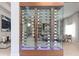 Custom wine cellar with glass enclosure and wooden accents, displaying an extensive collection at 1014 Jack Nicklaus Ct, Reunion, FL 34747