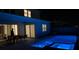 Relaxing backyard at night with a patio seating area and a pool with blue lights at 10275 Park Estates Ave, Orlando, FL 32836