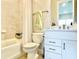 Well-lit bathroom with a combined shower and tub featuring tiled walls and modern fixtures at 10275 Park Estates Ave, Orlando, FL 32836