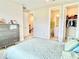 Comfortable bedroom showcasing a bed, doorways, and a gray dresser for ample storage at 10275 Park Estates Ave, Orlando, FL 32836