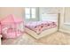 Bright bedroom featuring a bed with white trim and a pink tent with pillows, creating a cozy and playful atmosphere at 10275 Park Estates Ave, Orlando, FL 32836