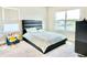 Bedroom featuring a modern bed, two windows with great light, and gray carpet at 10275 Park Estates Ave, Orlando, FL 32836