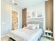 Bedroom view featuring a bed, decor, and an open door to a bathroom at 10275 Park Estates Ave, Orlando, FL 32836