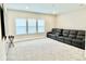 Large bonus room with plush carpeting, modern window treatments, and comfortable seating at 10275 Park Estates Ave, Orlando, FL 32836