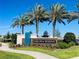 Parkview Reserve neighborhood sign with palm trees and lush landscaping under a clear blue sky at 10275 Park Estates Ave, Orlando, FL 32836