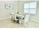 Dining room with modern table, six chairs, window, luxury vinyl plank flooring, and neutral decor at 10275 Park Estates Ave, Orlando, FL 32836