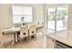 Bright dining area with a modern table setting and access to the outdoor patio at 10275 Park Estates Ave, Orlando, FL 32836