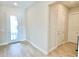 Bright entryway with wood-look tile flooring and a modern glass paneled front door at 10275 Park Estates Ave, Orlando, FL 32836