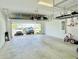 Spacious two-car garage featuring overhead storage racks and shelving, providing ample space for parking and organization at 10275 Park Estates Ave, Orlando, FL 32836
