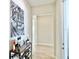 Neutral hallway with wood-look tile floors, decor, and access to multiple rooms at 10275 Park Estates Ave, Orlando, FL 32836