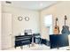 Versatile home office space features a piano, guitars, and ample space for work at 10275 Park Estates Ave, Orlando, FL 32836