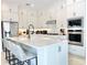 Well-equipped kitchen with a large island, stainless steel appliances, and sleek white cabinetry at 10275 Park Estates Ave, Orlando, FL 32836