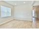 Minimalist living room with neutral paint, wood-look tile flooring, and a bright window at 10275 Park Estates Ave, Orlando, FL 32836