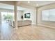 Open living room space showcasing neutral paint, wood-look tile flooring, and an adjacent patio at 10275 Park Estates Ave, Orlando, FL 32836