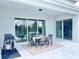 Covered outdoor patio with dining table, grill, and sliding glass doors for indoor/outdoor living at 10275 Park Estates Ave, Orlando, FL 32836