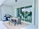 Covered outdoor patio with dining table, grill, and sliding glass doors for indoor/outdoor living at 10275 Park Estates Ave, Orlando, FL 32836