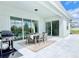 Covered outdoor patio with dining table, grill, and sliding glass doors for indoor/outdoor living at 10275 Park Estates Ave, Orlando, FL 32836