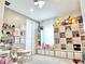 Spacious playroom with ample storage shelves, toys, table and chairs, perfect for organized play and creativity at 10275 Park Estates Ave, Orlando, FL 32836