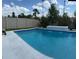 Beautiful in-ground pool featuring a tanning ledge, spa, and water feature at 10275 Park Estates Ave, Orlando, FL 32836