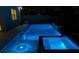 Night view of the backyard pool and spa with blue lighting at 10275 Park Estates Ave, Orlando, FL 32836