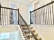 Carpeted staircase with decorative iron railings leads to the upper level at 10275 Park Estates Ave, Orlando, FL 32836